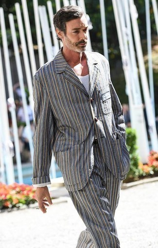 Vertical Striped Suit Smart Casual Outfits After 40: This combination of a vertical striped suit and a white tank is a fail-safe option when you need to look seriously stylish but have no time. Dressing inspo like this will help you remain enviously fashionable well into your 40s.