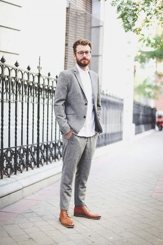 This polished combo of a grey wool suit and a white dress shirt is a common choice among the fashionable chaps. A pair of tan leather dress boots can integrate perfectly within a ton of outfits.
