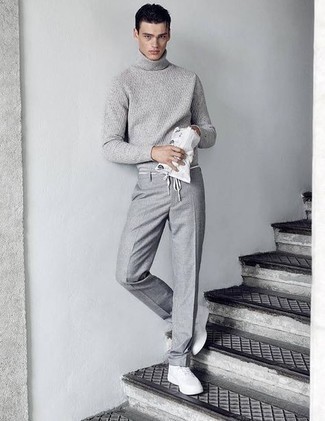 Charcoal Wool Turtleneck with White Canvas Low Top Sneakers Outfits For Men: To look like a stylish dandy at all times, go for a charcoal wool turtleneck and grey dress pants. Tone down the classiness of your ensemble with white canvas low top sneakers.