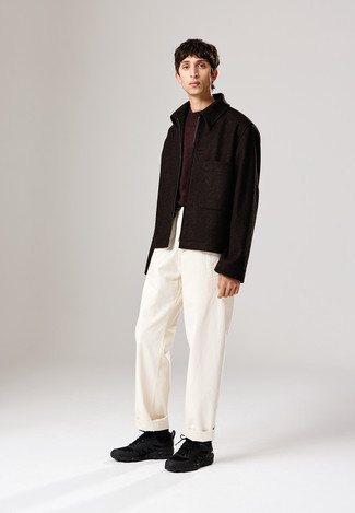 Dark Brown Crew-neck Sweater Outfits For Men: A dark brown crew-neck sweater and white chinos have become must-have closet must-haves for most gents. Complete your outfit with a pair of black athletic shoes to avoid looking too formal.