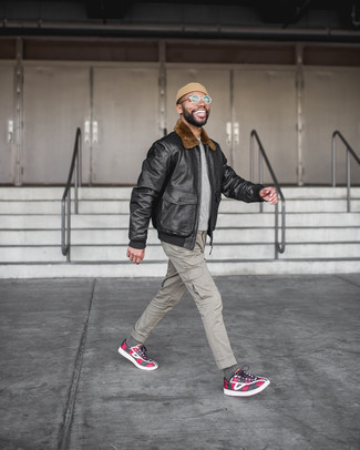 Red Low Top Sneakers Outfits For Men: No matter where the day takes you, you'll be stylishly ready in this casual combo of a black leather harrington jacket and grey cargo pants. This outfit is complemented really well with a pair of red low top sneakers.