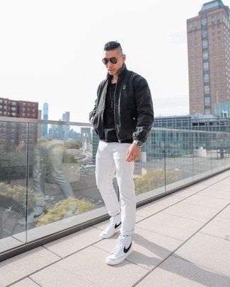 White and Black High Top Sneakers Outfits For Men: This off-duty combo of a charcoal harrington jacket and white jeans is perfect when you need to look casually stylish but have no extra time. If you wish to easily dial down this look with shoes, why not complete your ensemble with a pair of white and black high top sneakers?