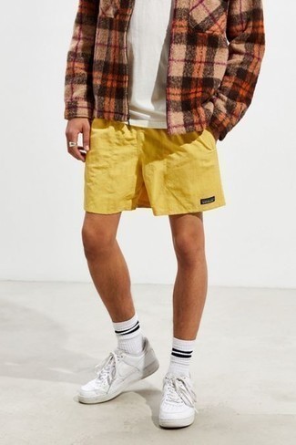 Mustard Shorts Outfits For Men: This pairing of a tan plaid harrington jacket and mustard shorts will be a good manifestation of your prowess in men's fashion even on lazy days. On the shoe front, this look pairs brilliantly with white leather low top sneakers.
