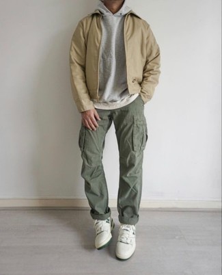 Olive Cargo Pants Outfits: Consider wearing a tan harrington jacket and olive cargo pants for a laid-back outfit with a modernized spin. White and green leather low top sneakers look right at home with this outfit.