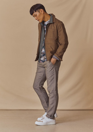 Grey Print Crew-neck T-shirt Outfits For Men: Such essentials as a grey print crew-neck t-shirt and brown chinos are the ideal way to introduce some cool into your casual arsenal. Add a pair of white leather low top sneakers to this outfit and ta-da: the look is complete.