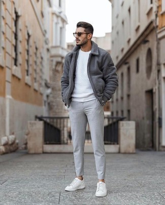 White Sweatshirt Outfits For Men: This combination of a white sweatshirt and grey chinos is undeniable proof that a simple casual outfit doesn't have to be boring. Our favorite of an infinite number of ways to complete this ensemble is white leather low top sneakers.