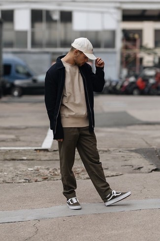 Olive Canvas Low Top Sneakers Outfits For Men: This pairing of a black harrington jacket and dark brown chinos will cement your prowess in men's fashion even on off-duty days. Don't know how to finish off? Add olive canvas low top sneakers to this ensemble to jazz things up.