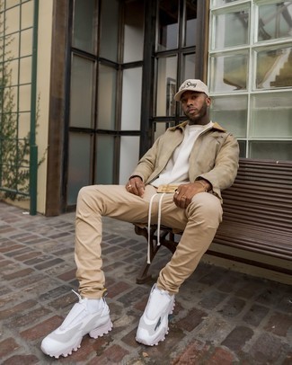White Sweatshirt Outfits For Men: This casual combo of a white sweatshirt and khaki chinos is a fail-safe option when you need to look cool in a flash. Let your outfit coordination chops really shine by rounding off your outfit with white athletic shoes.