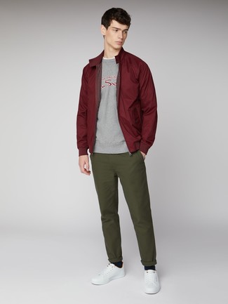 Grey Print Sweatshirt Outfits For Men: This combination of a grey print sweatshirt and olive chinos is a safe bet for an effortlessly dapper ensemble. Our favorite of a multitude of ways to finish this outfit is with a pair of white leather low top sneakers.