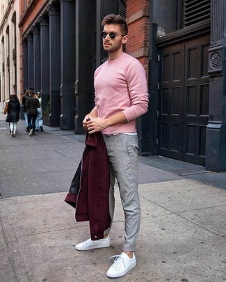 Pink Sweatshirt Outfits For Men: Fashionable and practical, this laid-back combination of a pink sweatshirt and grey chinos will provide you with amazing styling possibilities. A pair of white leather low top sneakers will be the ideal complement to this ensemble.
