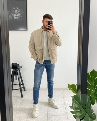 Blue Ripped Jeans Outfits For Men: If you put function above all, this off-duty combination of a beige corduroy harrington jacket and blue ripped jeans is your go-to. Go off the beaten path and jazz up your look by wearing white leather low top sneakers.