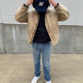 Sweatshirt Outfits For Men: Teaming a sweatshirt and blue jeans will be definitive proof of your expertise in menswear styling even on weekend days. Look at how great this outfit pairs with white leather low top sneakers.