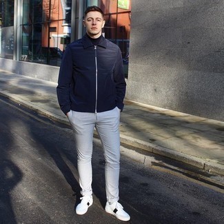Blue Harrington Jacket Outfits: Want to infuse your menswear arsenal with some fashion-forward cool? Try pairing a blue harrington jacket with grey chinos. Infuse some stylish nonchalance into your look with the help of white and black leather low top sneakers.