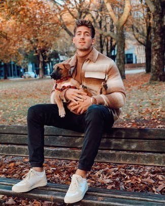 Beige Turtleneck Outfits For Men: A beige turtleneck and navy jeans are the kind of a winning casual getup that you so terribly need when you have no extra time. Let your outfit coordination skills truly shine by completing this outfit with white canvas low top sneakers.