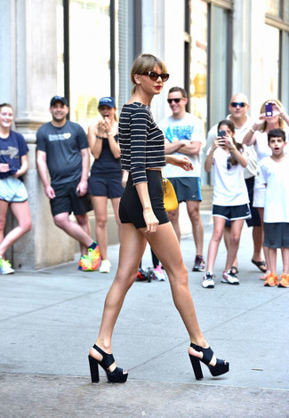 Taylor Swift wearing Yellow Leather Handbag, Black Chunky Leather Heeled Sandals, Black Shorts, Navy and White Horizontal Striped Cropped Sweater