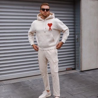White Print Hoodie Outfits For Men: If you're on the lookout for a casual street style yet sharp getup, marry a white print hoodie with beige cargo pants. For something more on the sophisticated side to round off this ensemble, complete your outfit with a pair of white canvas low top sneakers.