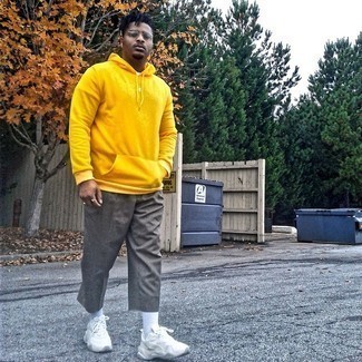 Mustard Hoodie Outfits For Men: This pairing of a mustard hoodie and grey chinos offers comfort and utility and helps keep it simple yet current. Finishing with a pair of white athletic shoes is a surefire way to infuse a hint of stylish casualness into this look.