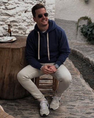 Navy Hoodie Outfits For Men: A navy hoodie and beige chinos paired together are a perfect match. Rev up the cool of this look by wearing a pair of beige athletic shoes.