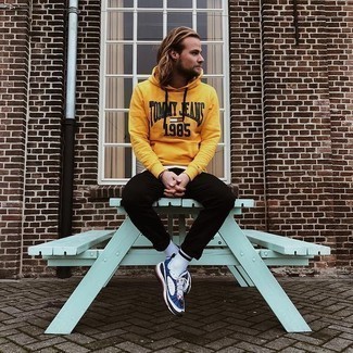 White and Navy Athletic Shoes Outfits For Men: A mustard print hoodie and black chinos will infuse your current rotation this relaxed and dapper vibe. To give your overall ensemble a more laid-back feel, introduce a pair of white and navy athletic shoes to the mix.