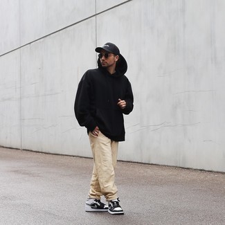 Men's Black Hoodie, Beige Chinos, White and Black Leather High Top Sneakers, Black and White Print Baseball Cap