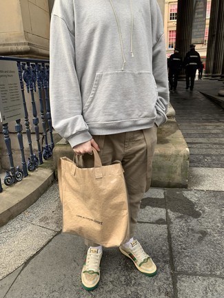 Beige Canvas Tote Bag Outfits For Men: To don a casual outfit with an edgy finish, you can go for a grey hoodie and a beige canvas tote bag. To give your overall look a more sophisticated aesthetic, complement this outfit with beige print canvas low top sneakers.