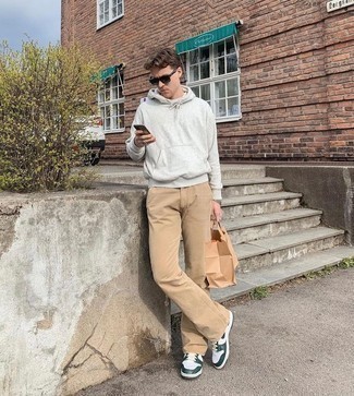 White and Green Leather Low Top Sneakers Outfits For Men: A grey hoodie looks especially nice when paired with khaki chinos. A pair of white and green leather low top sneakers integrates seamlessly within a ton of looks.