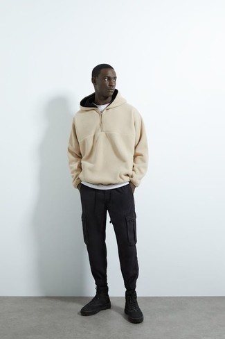 Black Cargo Pants Outfits: A beige fleece hoodie and black cargo pants worn together are a good match. Black canvas high top sneakers act as the glue that ties your look together.