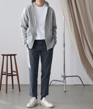 Chinos Outfits: Pairing a grey hoodie with chinos is an awesome choice for a relaxed casual ensemble. Introduce a pair of white canvas low top sneakers to the equation and you're all done and looking spectacular.