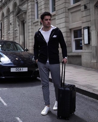 Black Suitcase Outfits For Men: Make a black hoodie and a black suitcase your outfit choice to achieve an interesting and urban ensemble. Add a pair of white canvas low top sneakers to the mix to immediately up the fashion factor of this look.