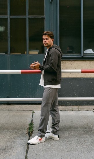 Charcoal Hoodie Outfits For Men: A charcoal hoodie and grey chinos matched together are a perfect match. Our favorite of an endless number of ways to finish off this getup is with a pair of white print canvas low top sneakers.