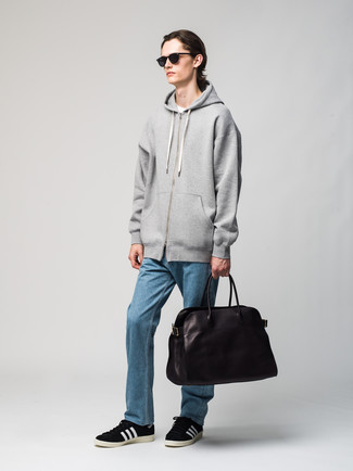 Dark Brown Leather Tote Bag Outfits For Men: This relaxed combination of a grey hoodie and a dark brown leather tote bag is a safe option when you need to look dapper in a flash. Feeling experimental? Mix things up by slipping into black and white suede low top sneakers.