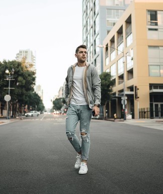 White and Green Leather Low Top Sneakers Outfits For Men: A grey hoodie and light blue ripped jeans are surely worth being on your list of menswear staples. Go ahead and add white and green leather low top sneakers to the equation for a sense of sophistication.