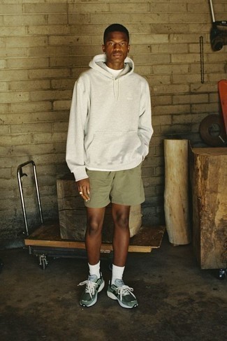121 Relaxed Outfits For Men: This casual combination of a grey hoodie and olive shorts is super easy to throw together in seconds time, helping you look on-trend and prepared for anything without spending too much time rummaging through your closet. Balance out this ensemble with more relaxed footwear, such as these dark green athletic shoes.