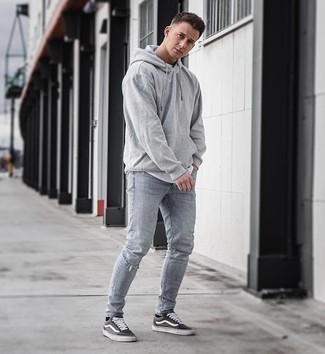 Grey Hoodie Outfits For Men: We're all after practicality when it comes to styling, and this contemporary pairing of a grey hoodie and light blue ripped skinny jeans is a practical example of that. Charcoal canvas low top sneakers are an easy way to transform this look.