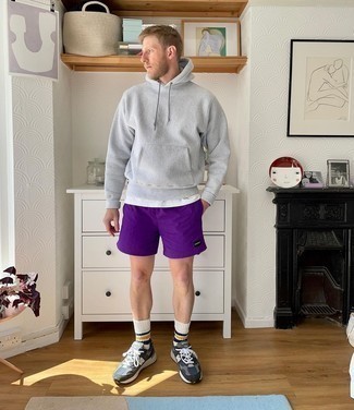 Violet Sports Shorts Outfits For Men: Pair a grey hoodie with violet sports shorts for an unexpectedly cool outfit. Complement this outfit with navy and white athletic shoes and the whole getup will come together.