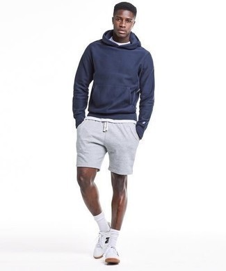 Grey Sports Shorts Outfits For Men: This contemporary pairing of a navy hoodie and grey sports shorts is super easy to put together without a second thought, helping you look sharp and ready for anything without spending a ton of time going through your closet. And if you need to easily rev up this outfit with one single item, introduce white and black print canvas low top sneakers to your outfit.