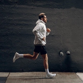 500+ Relaxed Warm Weather Outfits For Men: A grey hoodie and navy sports shorts are both versatile menswear essentials that will integrate wonderfully within your current rotation. Rock a pair of white athletic shoes and ta-da: the outfit is complete.