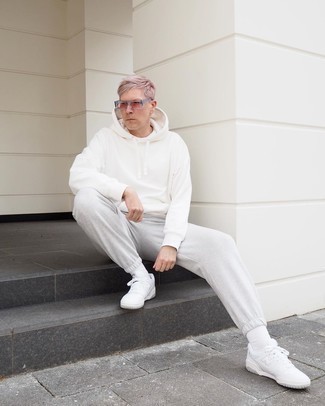 White Leather Low Top Sneakers Outfits For Men: The go-to for a killer casual look? A white hoodie with grey sweatpants. A trendy pair of white leather low top sneakers is a simple way to punch up this look.