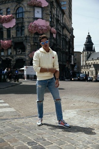 Beige Print Hoodie Outfits For Men: If you gravitate towards relaxed getups, why not test drive this combo of a beige print hoodie and light blue ripped jeans? Add light blue athletic shoes to your look to pull your full getup together.