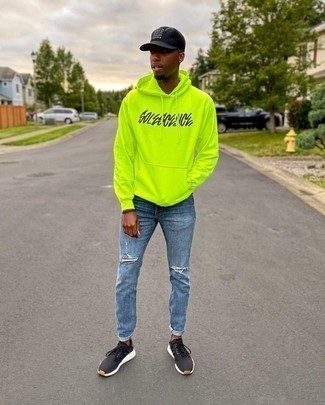 Green-Yellow Print Hoodie Outfits For Men: If you enjoy practical outfits, go for a green-yellow print hoodie and blue ripped jeans. Complement this outfit with black and white athletic shoes and ta-da: the look is complete.