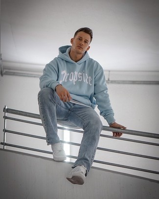 Light Blue Print Hoodie Outfits For Men: Choose a light blue print hoodie and light blue jeans to pull together an interesting and bold casual outfit. The whole ensemble comes together perfectly if you complete this look with a pair of white leather low top sneakers.