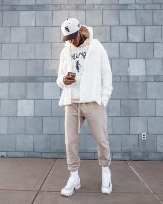 White and Brown Baseball Cap Outfits For Men: Hard proof that a white and black print hoodie and a white and brown baseball cap are awesome when matched together in a street style outfit. A pair of white athletic shoes immediately revs up the fashion factor of your getup.