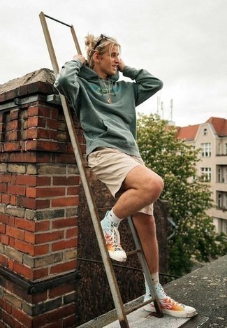 Tan Shorts Outfits For Men: A mint print hoodie and tan shorts are the kind of a no-brainer off-duty look that you need when you have no extra time. For extra style points, add a pair of multi colored print canvas high top sneakers to the equation.