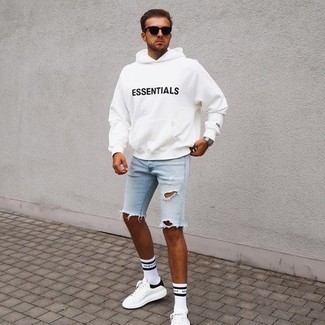 White Print Hoodie Outfits For Men: This is definitive proof that a white print hoodie and light blue ripped denim shorts look awesome when worn together in a laid-back look. White and black leather low top sneakers introduce a sophisticated aesthetic to the getup.
