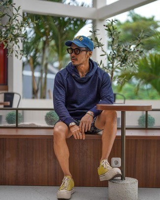 Yellow Low Top Sneakers Outfits For Men: In situations comfort is essential, make a navy hoodie and black paisley shorts your outfit choice. We're loving how this whole ensemble comes together thanks to yellow low top sneakers.