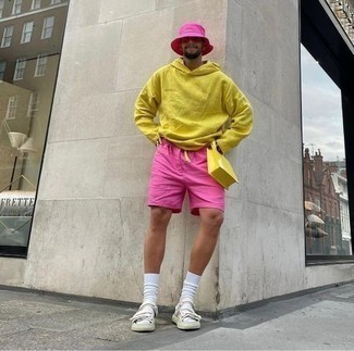 White Sandals Outfits For Men: Reach for a mustard hoodie and hot pink shorts for a dapper, relaxed casual look. For something more on the casually cool end to complete your look, introduce white sandals to this ensemble.