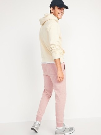 Pink Sweatpants Outfits For Men: A beige hoodie and pink sweatpants combined together are a savvy match. All you need is a pair of grey athletic shoes.