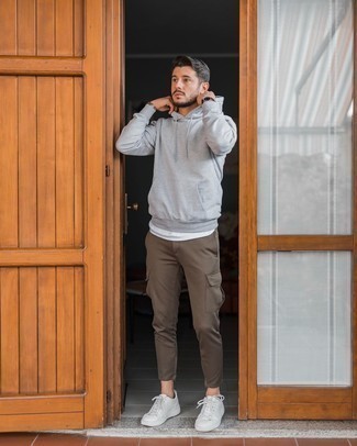 Grey Hoodie Outfits For Men: The versatility of a grey hoodie and brown cargo pants guarantees you'll have them on heavy rotation in your wardrobe. If you're not sure how to finish, complete your outfit with white leather low top sneakers.