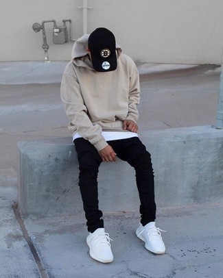 White Athletic Shoes Outfits For Men: A beige hoodie and black skinny jeans are the perfect base for a casually cool ensemble. Add a pair of white athletic shoes to the equation for extra style points.