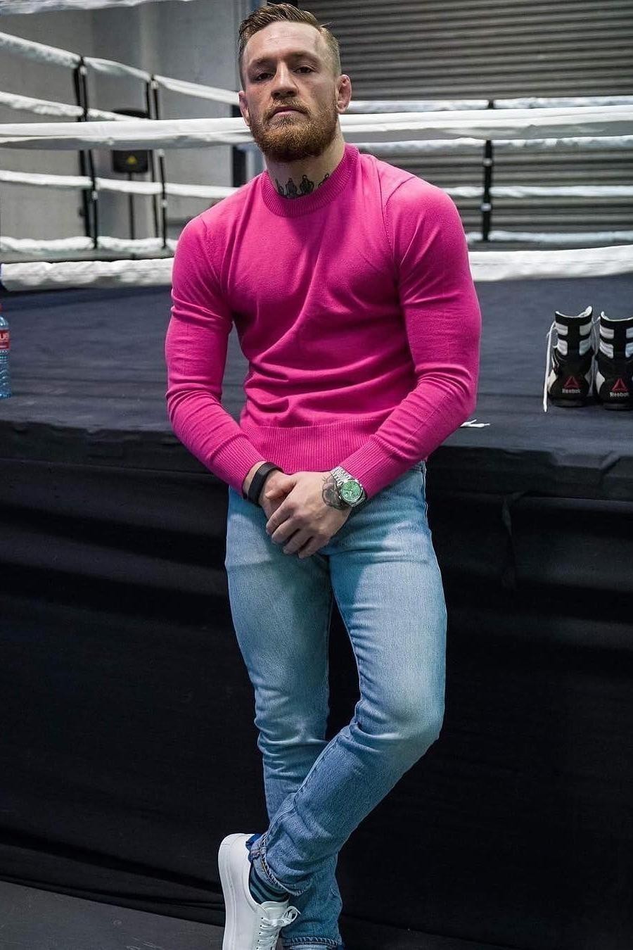 Conor McGregor wearing Hot Pink Crew-neck Sweater, Light Blue Skinny Jeans,  White Leather Low Top Sneakers | Lookastic